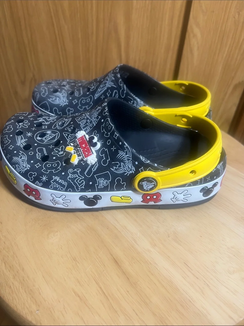 CROCS Kids Black Clogs with Yellow Heel Straps and White Doodle Prints